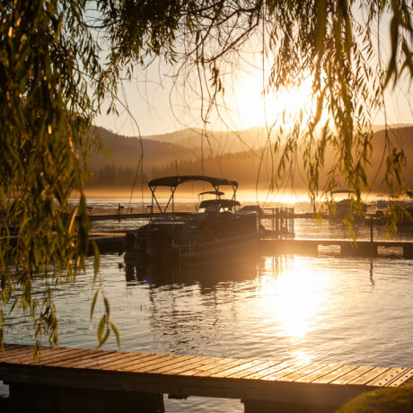 Lakefront view at Waitts Lake featuring dock, boats, and tranquil shoreline