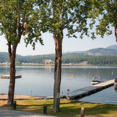 Fishing dock extending into Waitts Lake with clear blue skies overhead