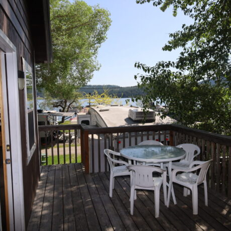 Cozy porch at Cabin 4 with table and chairs overlooking nature